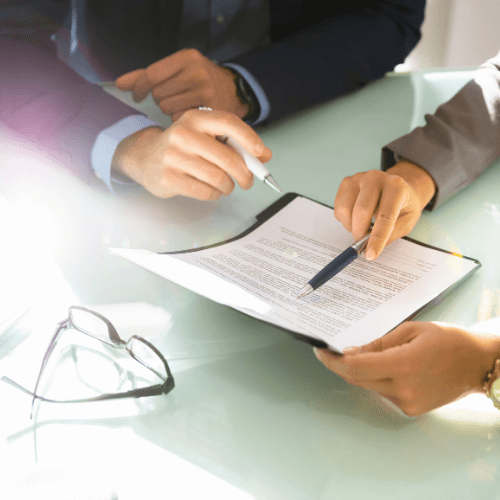 program-outline Two contractors reviewing paperwork for program outlines
