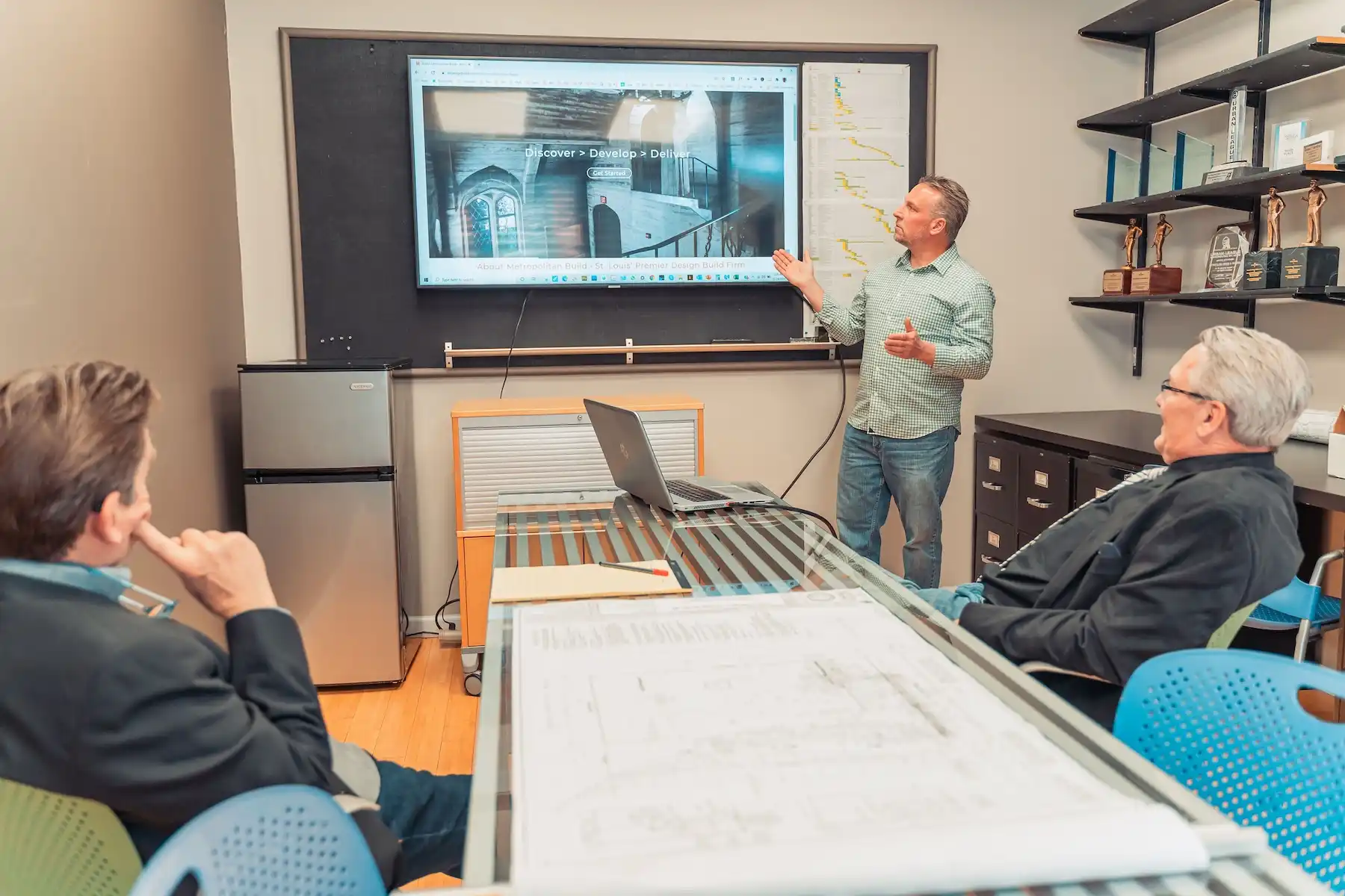 Metropolitan Build Design-Build Construction Firm team meeting to review project plans and processes
