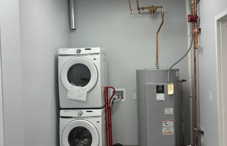Post-construction snapshot of laundry area with stacked washer and dryer